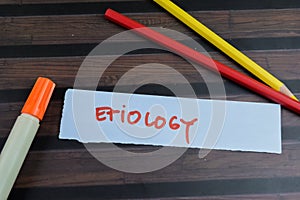Concept of Etiology write on sticky notes isolated on Wooden Table