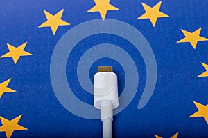 Concept for EU law to force USB-C chargers for all phones. EUROPEAN UNION flag and USBC universal