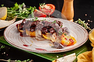 The concept of European cuisine. Grilled beef liver with caramelized fruit, pear, orange and onion. Serving dishes