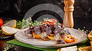 The concept of European cuisine. Grilled beef liver with caramelized fruit, pear, orange and onion. Serving dishes