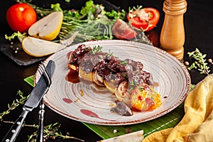 The concept of European cuisine. Grilled beef liver with caramelized fruit, pear, orange and onion. Serving dishes