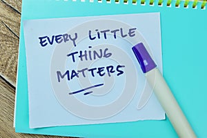 Concept of Every Little Thing Matters write on sticky notes isolated on Wooden Table