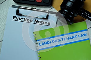 Concept of Eviction Notice text on Document and book Landlord-Tenant Law isolated on Wooden Table