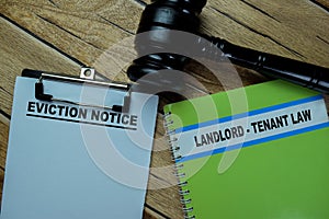 Concept of Eviction Notice write on paperwork and Landlord - Tenant Law on a book isolated on Wooden Table
