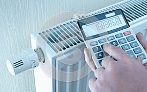 Concept of expensive heating costs. hands with calculator consider cost of heating. saving energy in times of crisis caused by