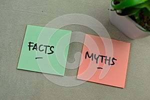 Concept of Facts or Myths write on sticky notes isolated on Wooden Table photo