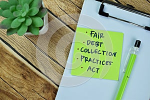Concept of Fair, Debt, Collection, Practices, Act write on sticky notes isolated on Wooden Table