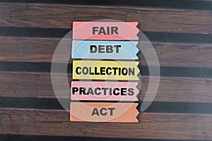 Concept of Fair, Debt, Collection, Practices, Act write on sticky notes isolated on Wooden Table