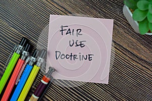 Concept of Fair Use Doctrine write on sticky notes isolated on Wooden Table photo