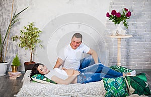 Happy beloved man and pregnant woman at home