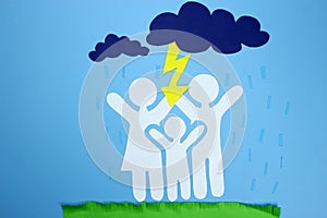 Concept of family safety. Paper origami family. Lightning strikes from the cloud