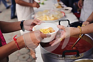 Concept of famine and social inequality : feeding food for beggar poverty concept : The society of helping to share food to the