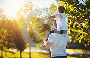 Concept of father`s day! happy family dad and child daughter back  in nature