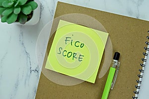 Concept of Fico Score write on sticky notes isolated on Wooden Table photo