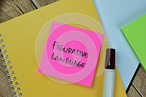 Concept of Figurative Language write on sticky notes isolated on Wooden Table