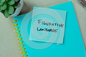 Concept of Figurative Language write on sticky notes isolated on Wooden Table