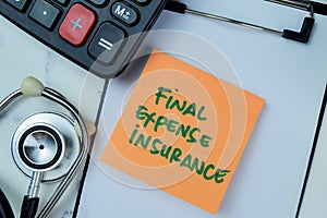 Concept of Final Expense Insurance write on sticky notes with stethoscope and calculator isolated on Wooden Table