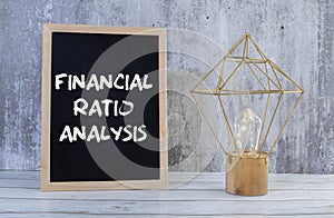 Concept of Financial Ratio Analysis write on sticky notes isolated on Wooden Table.