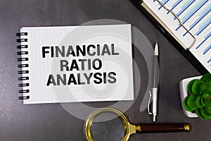 Concept of Financial Ratio Analysis write on sticky notes isolated on Wooden Table