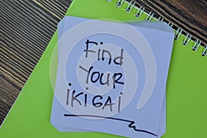 Concept of Find Your Ikigai write on sticky notes isolated on Wooden Table photo