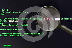 The concept of finding errors in computer programs. The magnifier is on a black background with green text. Software testing