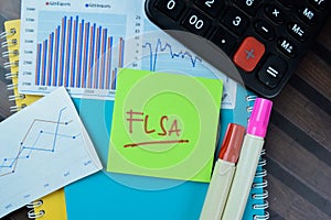Concept of FLSA write on sticky notes isolated on Wooden Table