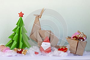 Concept fold the paper into a Christmas tree, Santa Cross, Reindeer and giff. photo