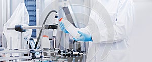 Concept food industry banner. Worker inspecting production line bottle in of beer or dairy factory