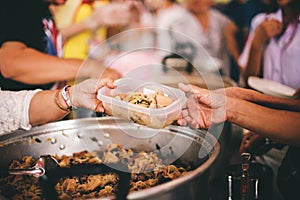 The concept of food shortage, hungry people offer food donations from volunteers who have donated free charity food