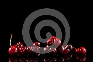 Concept -  Food waste reduction. Heap of fresh doubles cherry berries cherries on a dark background with reflection. Selective
