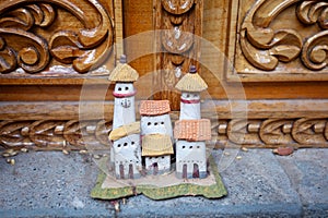 The concept of a forgotten dream about a personal home. Old statuette of a house with a tower.