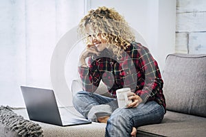 Concept of free and hapy people work with computer technology at home not office - cheerful caucasian woman with laptop sit down