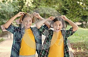 concept of friendship. small happy girls wear checkered shirt. kid casual fashion. childhood happiness. happy childrens