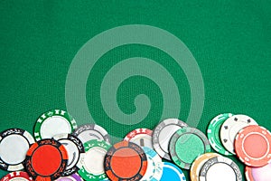 Concept of gambling in casino, sports poker. Colored gaming chips on green gaming table. Copy space for text.