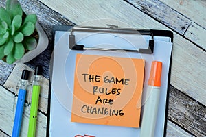 Concept of The Game Rules Are Changing write on sticky notes isolated on Wooden Table
