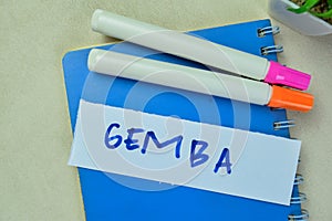 Concept of Gemba write on sticky notes isolated on Wooden Table photo