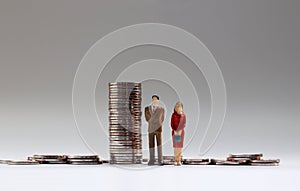 Miniature people and coins.