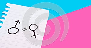 The concept of gender equality. Torn paper with painted female and male symbols on a blue-pink background. Equality of rights of