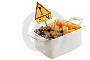 Concept of genetically modified organism with corn and peas in a ramekin with a road sign photo