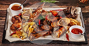 Concept of Georgian cuisine. Large meat board with shashlik, roasted meat, french fries, roast lamb and sauce. Serving dishes