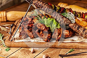 Concept of Georgian cuisine. Meat board with shashlik, grilled pork ribs, lulya kebab and shish kebab. Grilled french fries