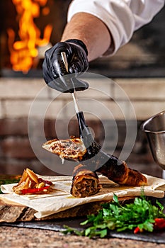 The concept of Georgian cuisine. Recipe for cooking meat lyulya kebab in the dough on the grill. Chef puts meat on skewer