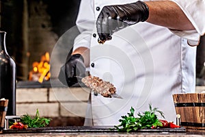 The concept of Georgian cuisine. Recipe for cooking meat lyulya kebab in the dough on the grill. Chef puts meat on skewer