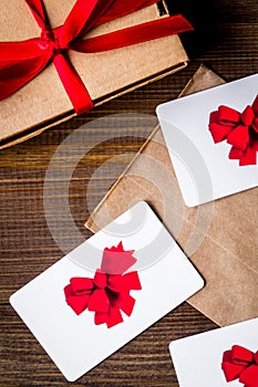 Concept of gift cards on wooden background top view