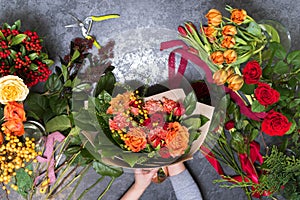 The concept of gifts and bouquets for March 8 and Mother`s Day. Florist creates a bouquet in a flower shop