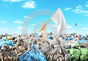 Concept of global pollution. A hand with a white flag sticks out