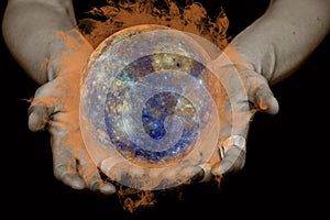 The concept of global warming. Male hands hold a burning globe on a black isolated background. Elements of this image