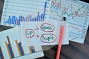 Concept of GP - Gross Profit write on sticky notes isolated on Wooden Table