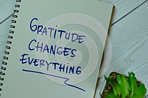 Concept of Gratitude Changes Everything write on a book isolated on Wooden Table