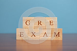 Concept of GRE Exam in wooden block letters on table